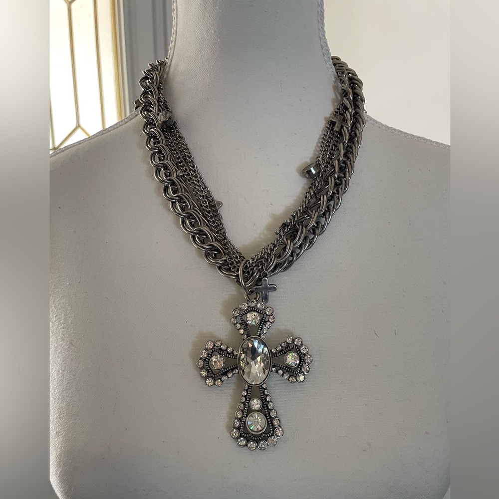 Silver tone multi chain necklace w/cross pendant.